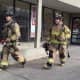 Teaneck firefighters exit Amazing Savings Tuesday morning after responding to a false alarm.
