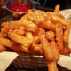 The truffle fries at The Front Porch Pub in Hawthorne are big, crunchy, and sprinkled with parmesan cheese.