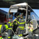 Norwalk firefighters work to free the driver pinned inside the bus.