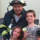 Park Ridge Firefighter Mario Izzo with two of his grandchildren, Mia and Timothy Izzo.