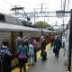 Commuters board trains at the South Norwalk Train Station on Monday.