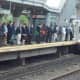 Commuters line up to board a train in Stamford, where trains are running on a normal schedule. 