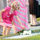 A child places a white rose on the 9/11 Memorial at Sherwood Island State Park in Westport at a past ceremony.