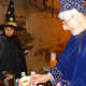 Witch Fran Greenburgh and helping wizard Bob Klein serve got apple cider to Dobbs Ferry trick-or-treaters.