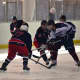 Harvey's Corey Eisenband fights for the puck against Stepinac. 