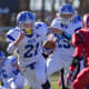 Darien's John Reed runs behind Nick Lombardo during the Thanksgiving game against New Canaan.