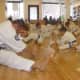 Stretching before a Saturday mass workout at Kenshikai Karate in Hastings.