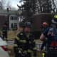 Fire crews battle a fire in a home in Larchmont on Thursday.