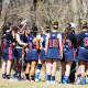 Harvey School girls lacrosse coach Greg Janos talks with his team during a recent game. 