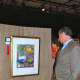 Darien resident Bob Marchesi views artwork at the 2013 Darien Art Show and Sale.