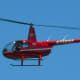 A zoomed version of a photo that shows a red helicopter flying over downtown Armonk.The helicopter's tail number is visible.