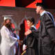 A Fox Lane High School graduate walks on stage during the presentation of diplomas.