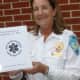Wendy Humboldt, captain of the New Canaan Volunteer Ambulance Corps, holds a book of 9/11 memories compiled by corps members.