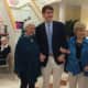 A Darien High School student is flanked by two Atria Darien Assisted Living residents at the Oct. 14 Pretty in Pink fashion show.
