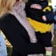 A baby is dressed as bumblebee. 