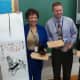Pocantico Hills Superintendent  Valencia Douglas receives a painted banner from Chinese educators who visited the school.
