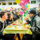 Volunteers and guests chat at Project SHARE's annual Thanksgiving dinner.