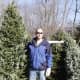 Chappaqua First Congregational Church member Rib Jakacki picks out a tree with his family as he stands next to a possible option.