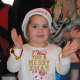 A child claps her hands and gets in the holiday spirit. 