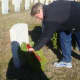 David Bayne lays a wreath at the grave of a veteran during Darien's ceremony.