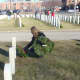 Darien First Selectman Jayme Stevenson lays several wreaths on the graves of veterans.
