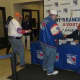 Jay Meyer, center, of New Rochelle gets a signature from Ranger Glenn Anderson, right.