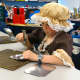 Croton-Harmon fourth graders created original design in the tin-smithing workshop during Colonial Day.