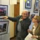 Visitors view photos at the Wilton Arts Council exhibit.