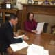 Gov. Dannel Malloy signs the executive order Monday in his office. 