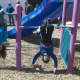 Kids take a moment to enjoy the park's playground area.
