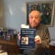Dr. Moshe Avital with one of his Holocaust-related books.