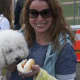 Catina Aspiazu, of Darien, and her poodle eye a hot dog. 