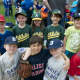 Little League players pose with friends. 