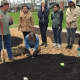 Jono Nieger and Laurie Weinstein demonstrate planting strawberries at the new permaculture garden at WCSU in Danbury.