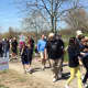 Hundreds of people walked the half-mile route up the beach at Sherwood Island State Park.
