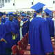 A graduate waves to the camera just prior to the start of the ceremonies.