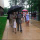 Umbrellas are a popular item as the rain forced the Wilton High graduation ceremonies indoors. 