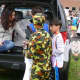Nicole Thornbrough, left, hands out candy on Wednesday during the Wilton Trunk Or Treat. 