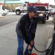 Stephen Jones of Pimpewaug Road in Wilton is taking the loss of power from Hurricane Sandy as best he can. He's pictured here at the Wheels Convenience gas station to get gas for his home's generator.  