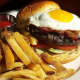 The Prime Beef Burger, featuring Allen Brothers USDA prime blend, applewood smoked bacon, blue cheese and a fried egg.