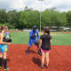 Mookie Wilson explaining proper fielding techniques to A-Game Sports campers in New Rochelle.