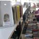 Shoppers look through the rows of books at the Westport Library.