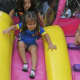 A girl takes a ride down the slide at Sunday's Ecuadorian Festival.