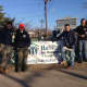 Members of the Venture Crew pose in front of the Habitat for Humanity sign. From left, Matt Jones, Ted Laquidara, Stephen Muoio and Gabe Frolick.
