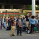 Passengers wait for buses to take them away from the scene of a two-train collision.