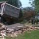 Authorities were trying to determine how to move the truck and how seriously damaged the house was.