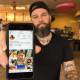 Matt Savage of Garfield displays his Instagram in a Lodi Dunkin Donuts.