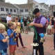 An expert delights the kids as he makes balloon animals and hats at the Slice of Saugatuck festival in Westport. 