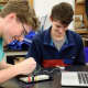 With their newly acquired knowledge, the students began building their circuits on real breadboards.