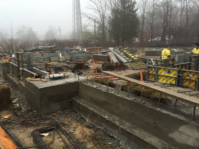 Workers dig out the foundation for the new West Milford Library in January.